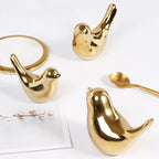 Ceramic bird figurines on shelf